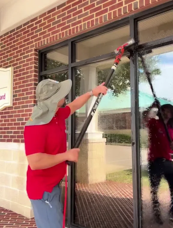 Window cleaning in progress at a commercial storefront.